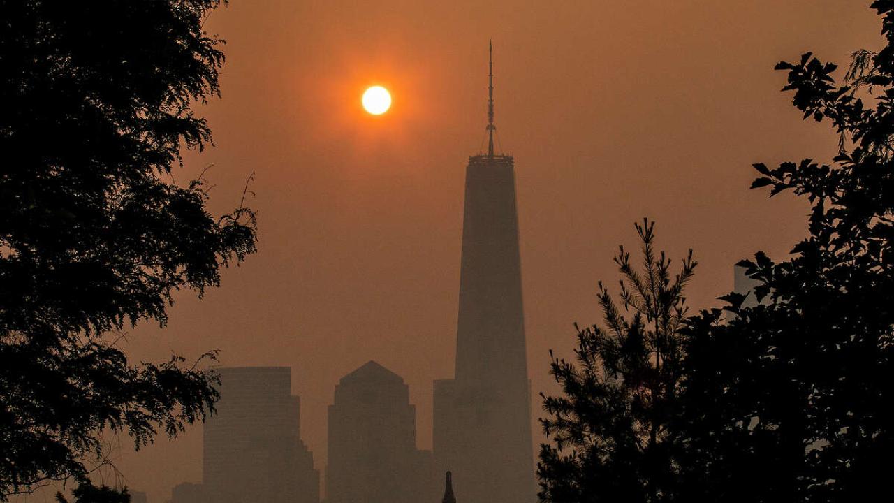The sun rising over New York City while wildfire smoke covers the city